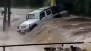 Storming South Texas River Swallows Jeep Wrangler