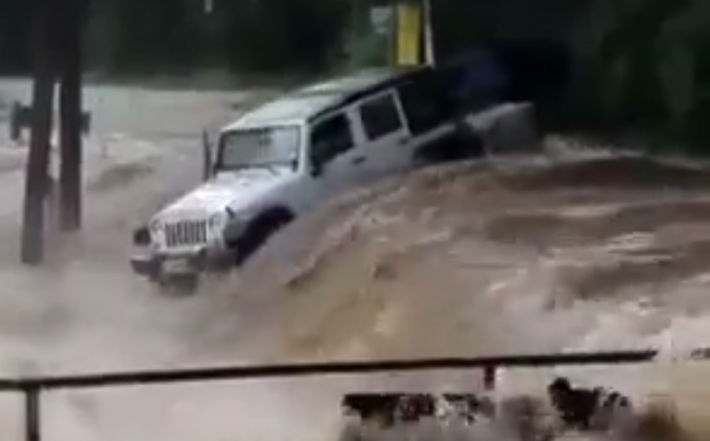Storming South Texas River Swallows Jeep Wrangler