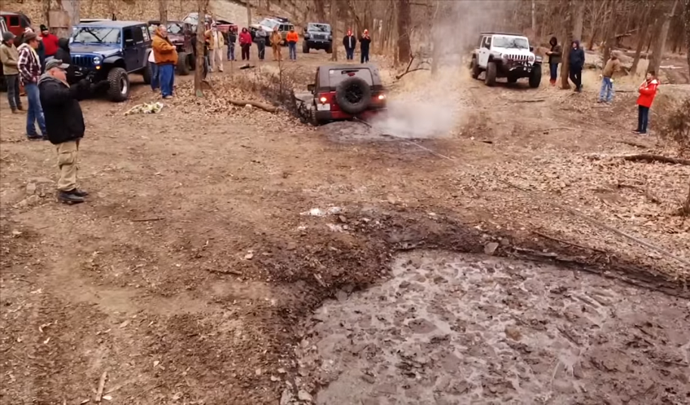 Jeep JL tows JK out of icy mud