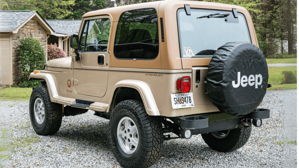 A tan 1994 Jeep Wrangler YJ